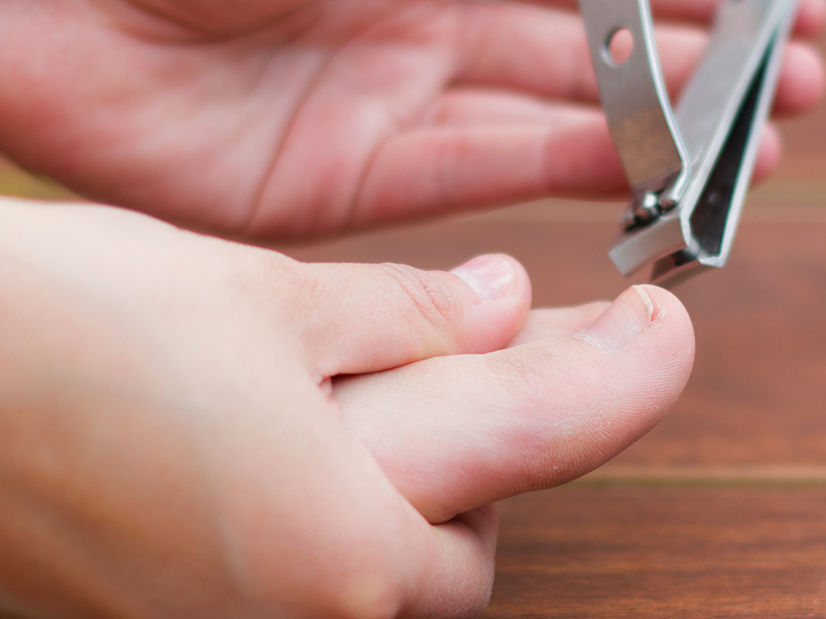 A person trimming their toenails
