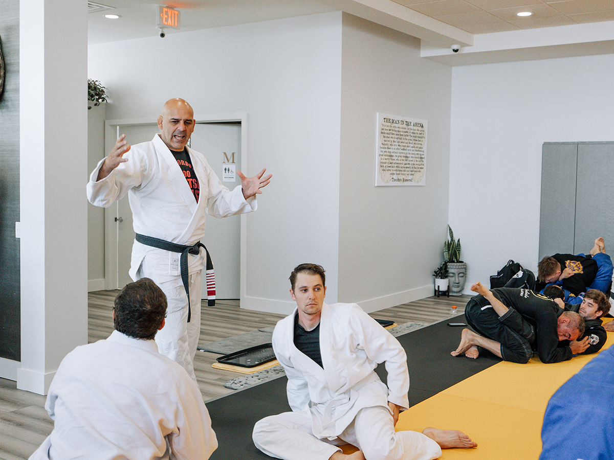 An instructor teaching a BJJ class
