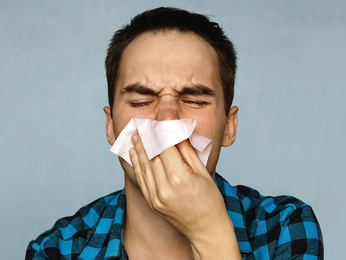 A person blowing their nose