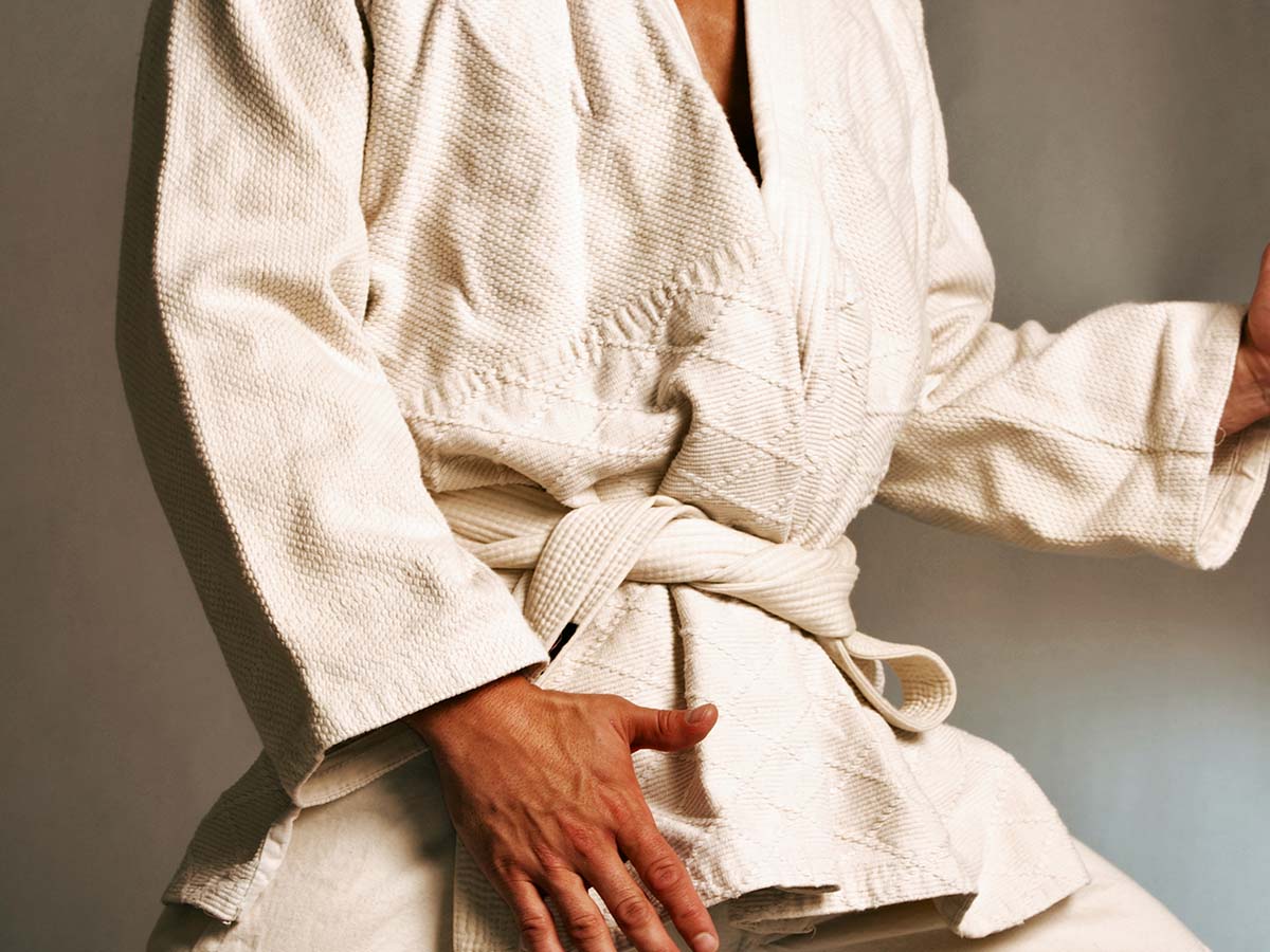 A man in a jiu jitsu outfit posing